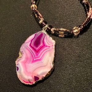 Beaded necklace with mixed purple stone. Clasp closure